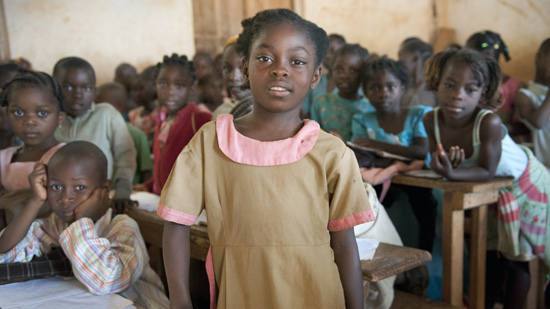 a young girl with her classmates in school